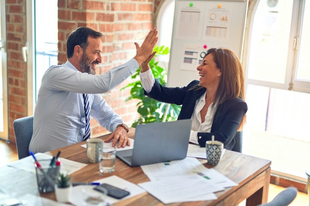 Small business owner celebrating marketing results with JST Digi strategist